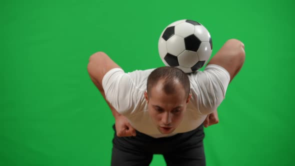 Young Caucasian Man Juggling Football Ball on Back in Slow Motion Catching with Hands