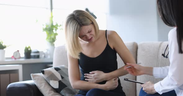 Doctor Conducts Medical Examination of Woman with Abdominal Pain at Home Closeup