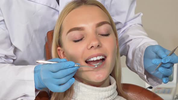 Happy Woman Smiling To the Camera After Getting Her Teeth Checked By Dentist