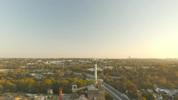 Still drone perspective looking across construction site and adjacent highway.