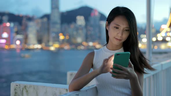 Woman use of mobile phone at night