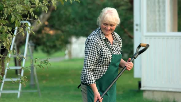 Female Gardener Smiling and Working