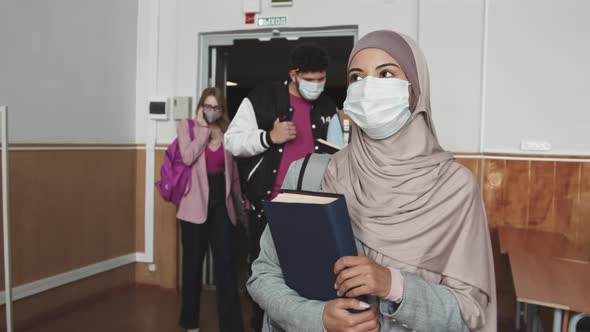 Diverse Students in Face Masks Entering Auditorium before Lesson