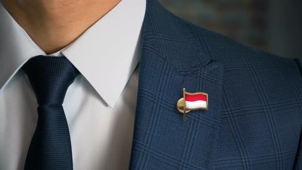 Businessman Walking Towards Camera With Country Flag Pin Indonesia