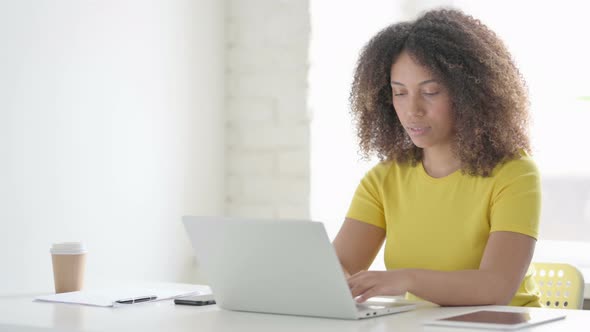 African Woman Reacting to Loss on Laptop