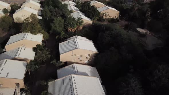 Aerial: top view of rooftops in the small village of Yotvata in the middle of the desert, Israel