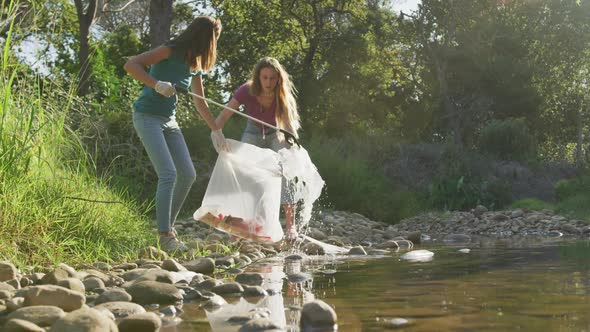 Mid adults volunteering during river clean-up day