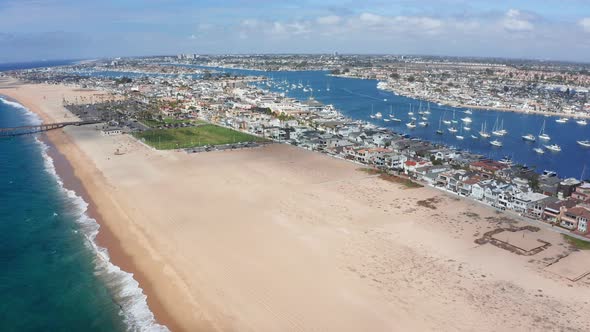 Balboa peninsula village and back bay at Newport beach in California, USA. Aerial wide view
