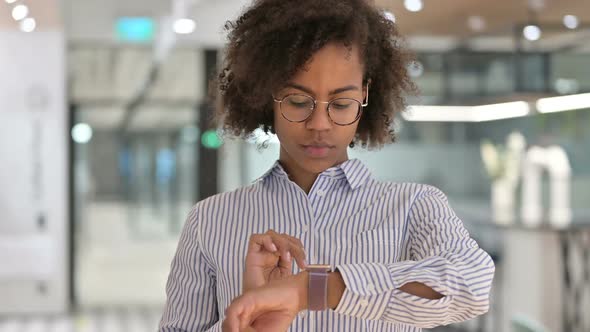 Young African Businesswoman Using Smartwatch