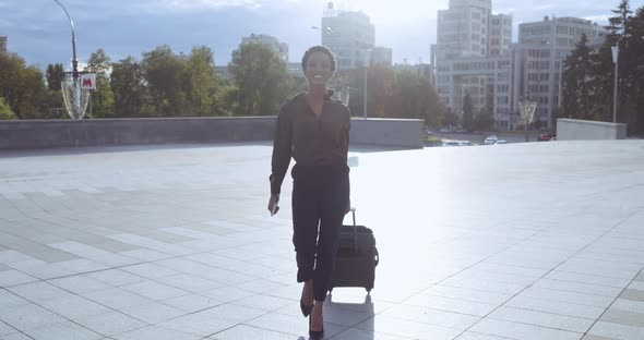 Happy Smiling African American Girl Going To Land Plane with Suitcase, Carries Passport and Tickets