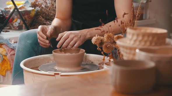 Pottery - a Man with an Iron Spatula Is Helping Himself Maintaining the Shape of a Bowl in Creative