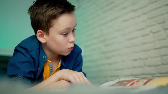 Self isolation concept. Young boy studying from home during Covid-19.