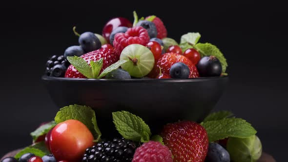 Mix of Wild Forest Berries on Black Background  UHD Video Footage