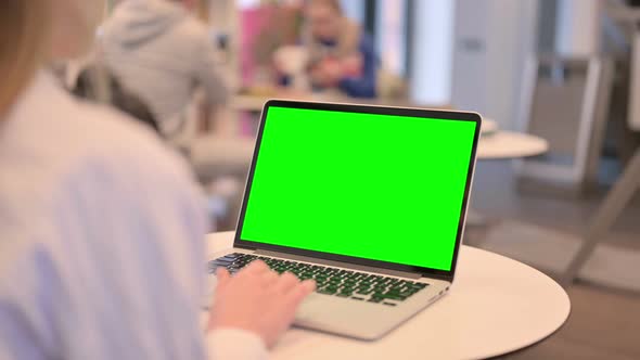 Woman Working on Laptop with Green Chroma Key Screen Rear View