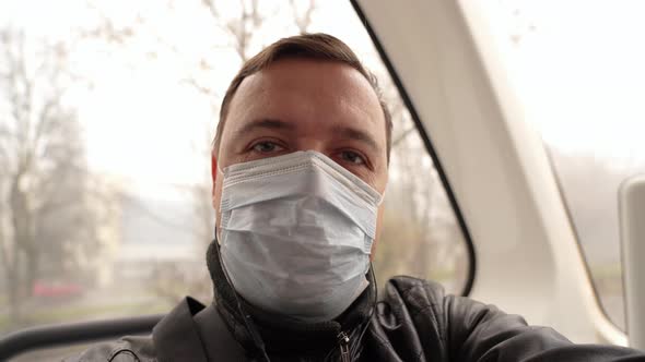 Portrait of Male Passenger Wearing Medical Face Mask Looking at Camera Thinking Going to Work