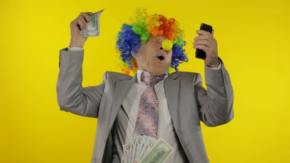 Clown Businessman Entrepreneur Boss Receives Money Income While Using Smartphone