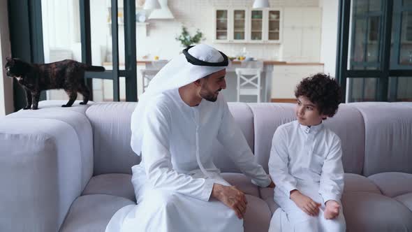 Father and son talking on the couch