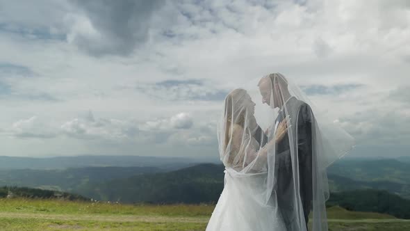 Groom with Bride Having Fun on a Mountain Hills. Wedding Couple. Happy Family