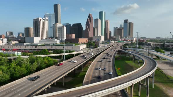 Downtown metro Houston Texas skyline. Rising aerial reveals cityscape. Interstate traffic circumvent