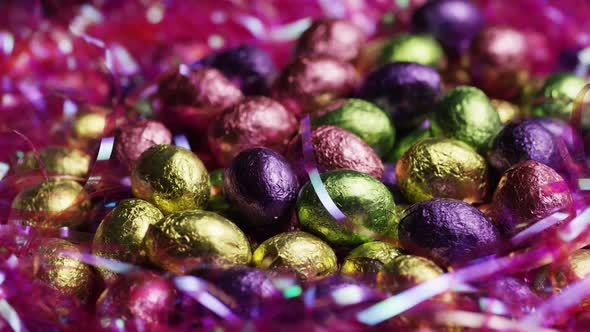 Rotating shot of colorful Easter candies on a bed of easter grass 