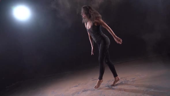 Young Dancer Woman Is Dancing in Dusty Dark Room, Energy and Active Dance