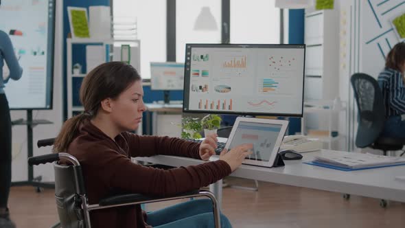 Project Manager with Disabilites Woman Using Computer and Tablet