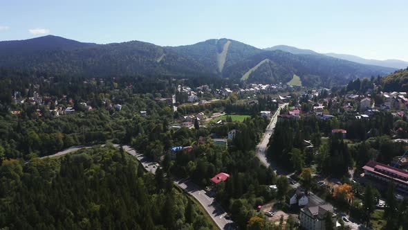 Aerial View Of The Predeal Rural Townscape And The Beautiful Clabucet Mountains In Romania.