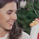 Cheerful Woman Smiling to the Camera Holding Toy Sant Claus - VideoHive Item for Sale