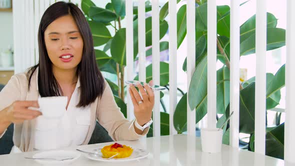 Woman Calling on Smartphone and Drinking Coffee