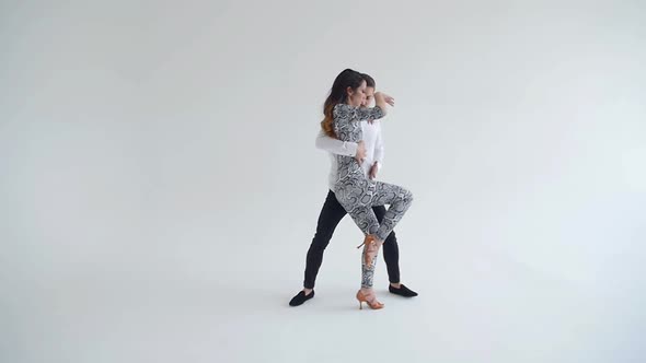 Concept of Love, Relationships and Social Dancing. Young Beautiful Couple Dancing Sensual Dance on a