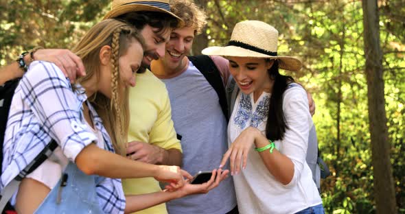 Hiker couples watching smartphone