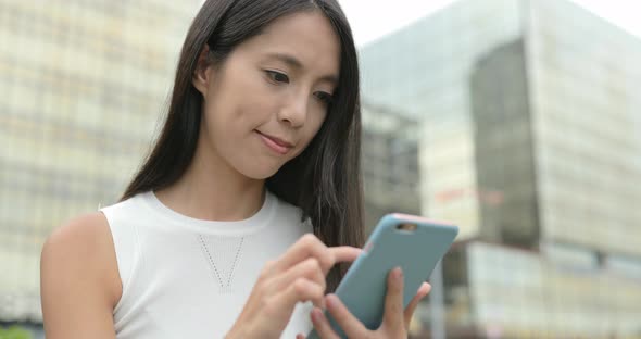 Woman use of mobile phone in city