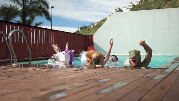 Crazy friends doing pool party wearing bizarre mask