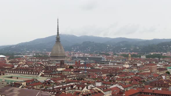 Colorful rooftops and landmark building with majestic tower, aerial view of Turin city