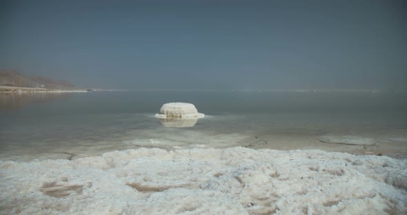 Tracking shot of salt deposits on the banks of the Dead Sea in israel