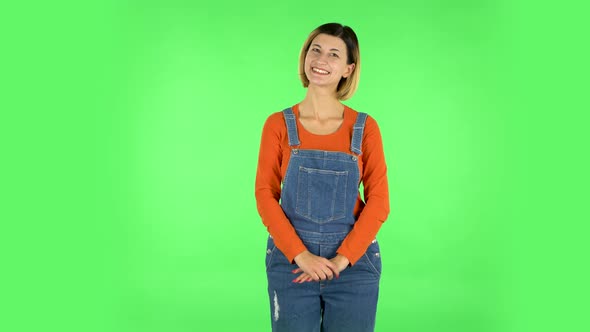 Cute Girl Smiles and Showing Heart with Fingers Then Blowing Kiss. Green Screen