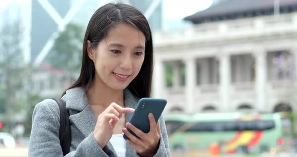 Businesswoman check on smart phone in city