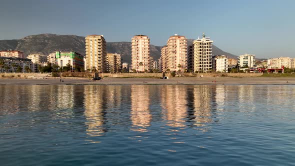 Reflection of the city in the sea aerial view 4 K