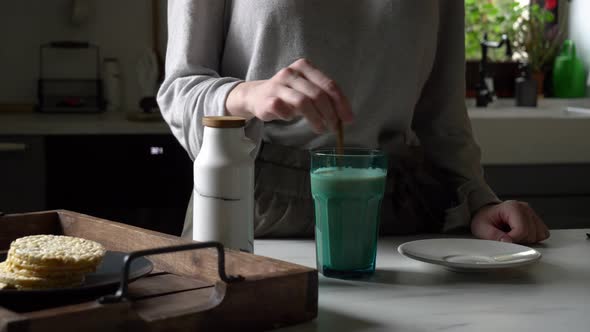 Woman and glass of coffee with milk