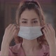 Joyful Woman Takes Off Surgical Mask On Her Face And Looks Directly At The Camera - VideoHive Item for Sale