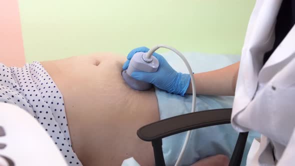 Closeup View of a Pregnant Womans Belly While Getting Ultrasound Scan By a Male Doctor