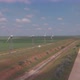 Aerial view of wind turbines energy production and road on fields - VideoHive Item for Sale