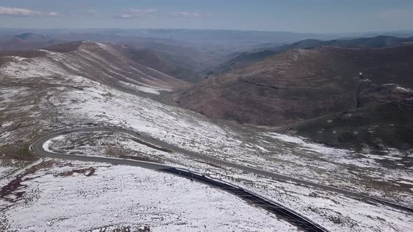 AERIALS of Snowy landscape in Lesotho, Africa - Snow fall in Africa Car driving on roads in snowy l
