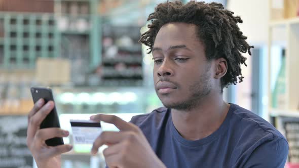 Portrait of Online Payment on Smartphone By African Man 