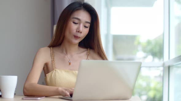 Young beautiful woman working with laptop at coffee shop