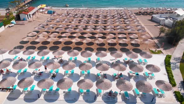 Flight Over the Beach with Umbrellas Towards the Pool in a Luxury Hotel
