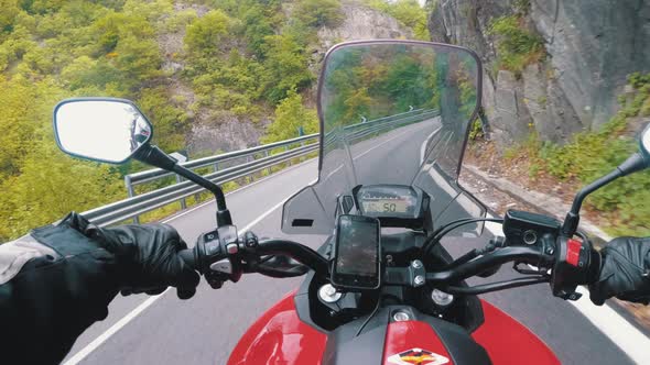 Motorcyclist on Motorbike Rides on a Beautiful Landscape Mountain Road in Italy