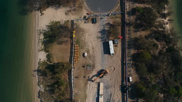 A construction site close to a major city undertaking infrastructure works on a coastal peninsular t