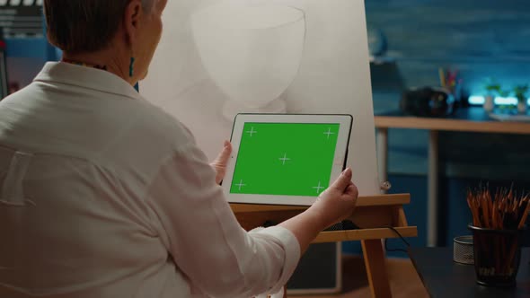 Old Artist Holding Digital Tablet with Greenscreen Template