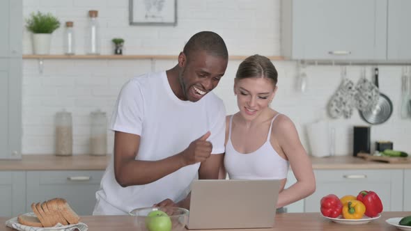 Sporty Woman and African Man Talking on Video Call in Kitchen